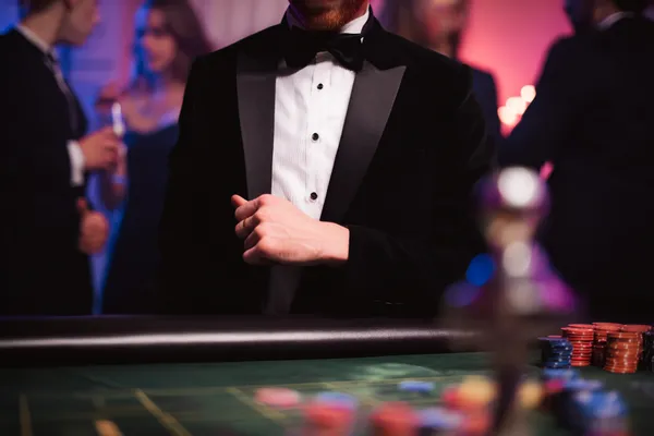 A young woman relaxing with her phone while dynamic casino elements float around her, illustrating the smooth mobile experience offered by the 5666BDT app.