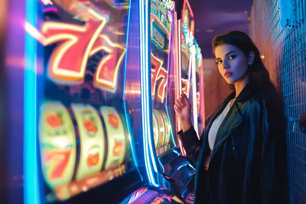A glamorous woman holding casino chips in a neon-lit environment, representing the premium online casino atmosphere of 5666BDT.